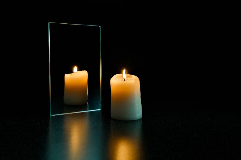 A scrying mirror with a candle.