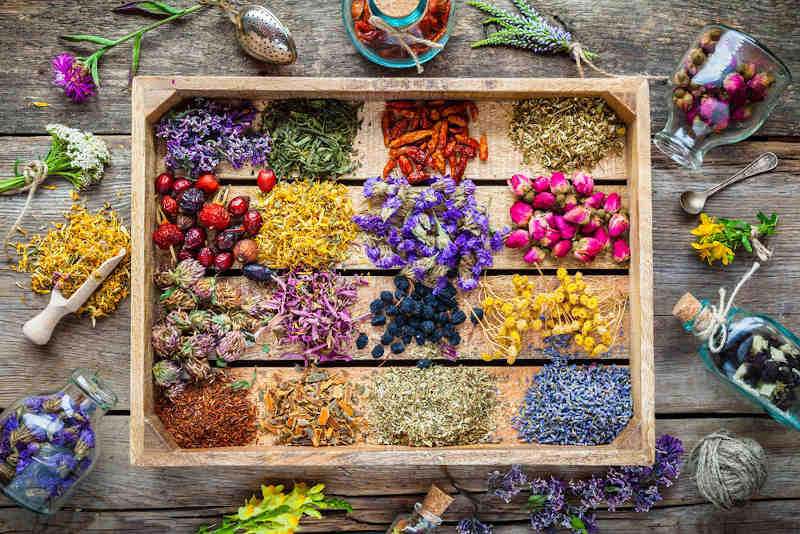 Herbs used for attracting love on a wooden table.