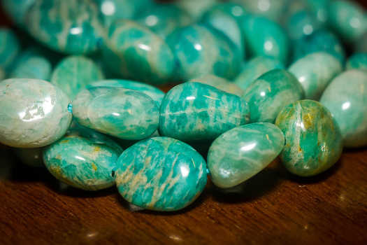 A pile of tumbled Amazonite crystals with magical and metaphysical properties. 