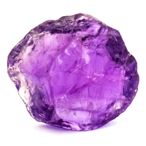A purple amethyst crystal isolated on a white background. 