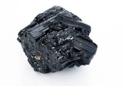 A black tourmaline stone isolated on a white background. 