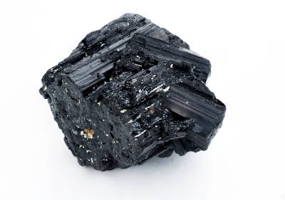 A black tourmaline crystal isolated on a white background. 