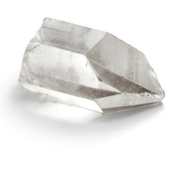 A transparent clear quartz crystal on a white background. 