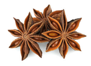 Three star anise pods on a white background. 