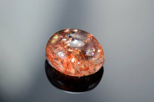 A shiny sunstone crystal with magical and metaphysical properties.