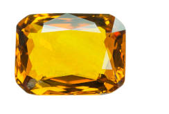A yellow sapphire crystal isolated on white. 